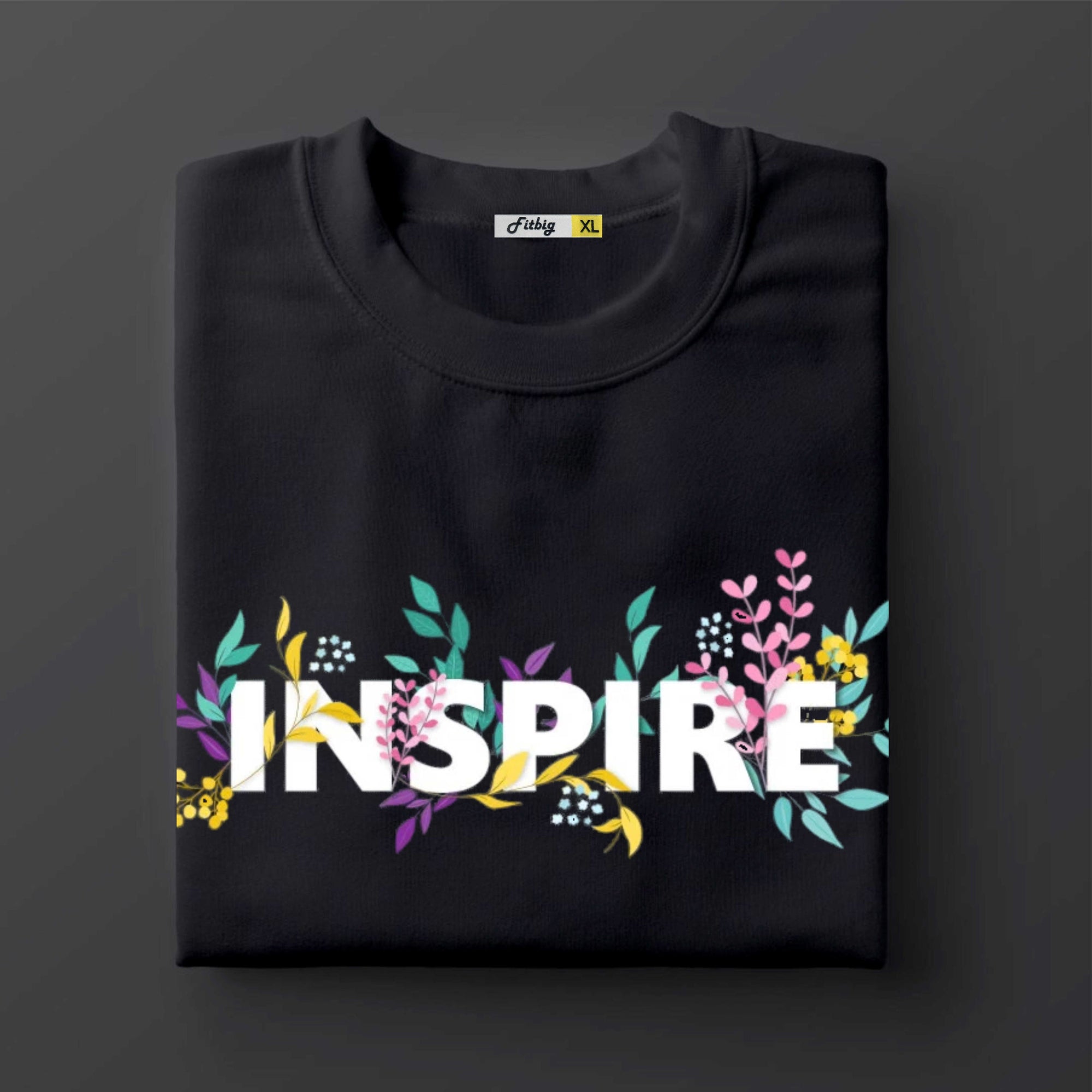 Black t shirt with 'INSPIRE' text and floral designs on a dark background