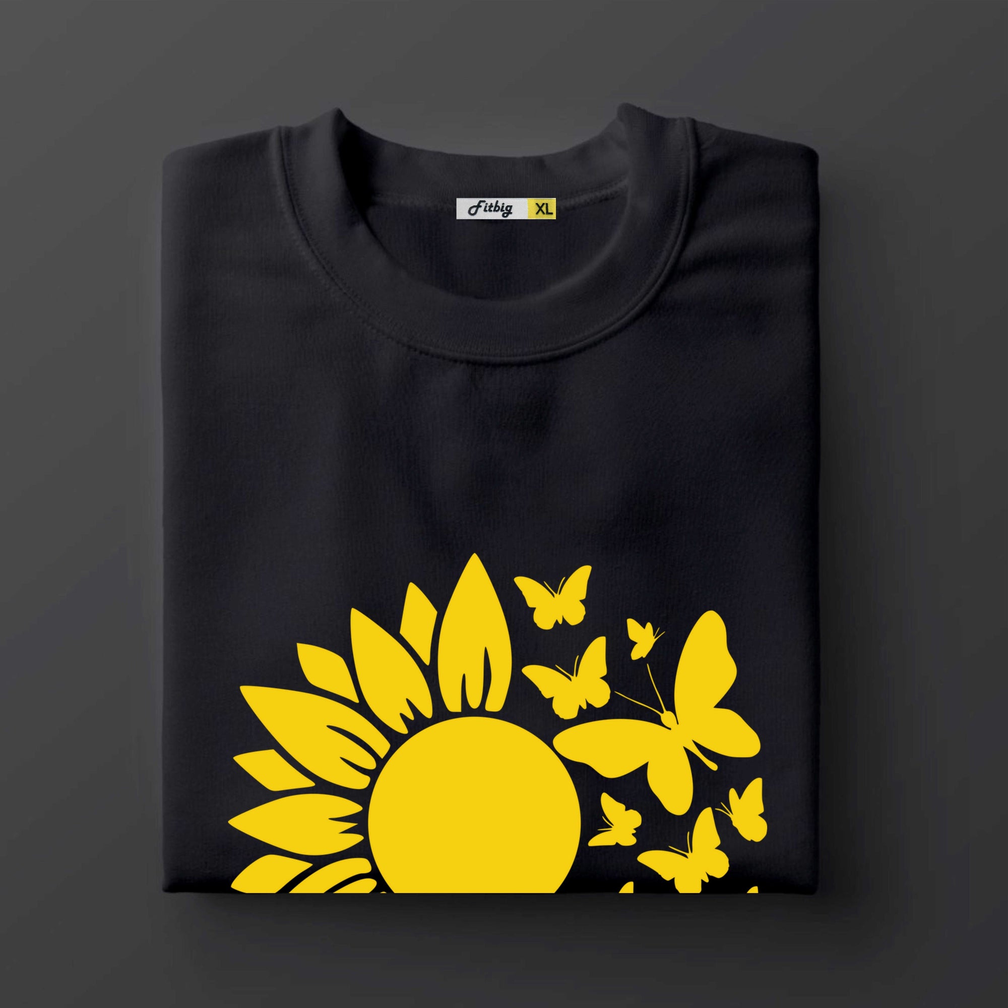 Black t shirt with a yellow sunflower and butterflies design on a dark background