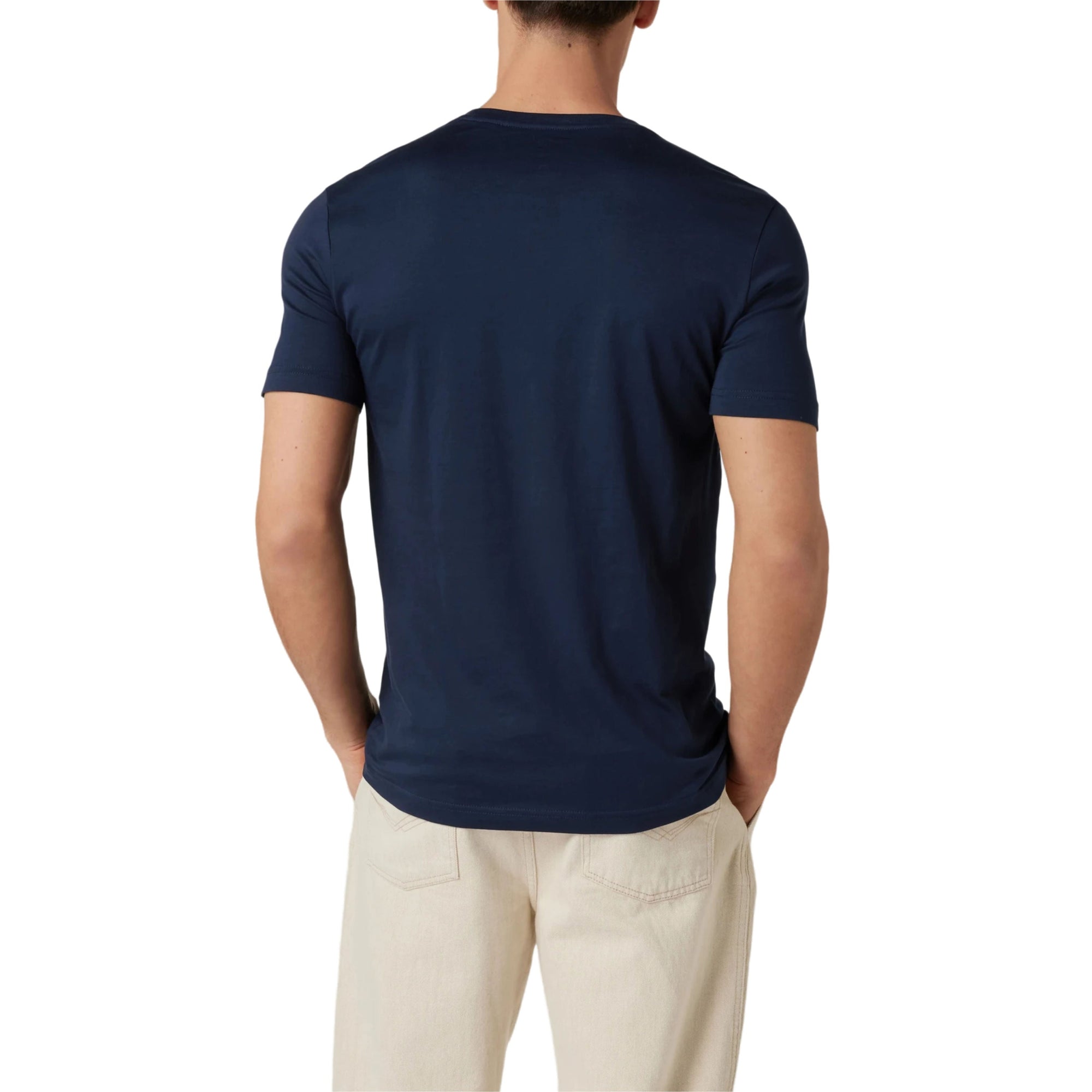 Person wearing a navy blue t-shirt and beige pants on a white background
