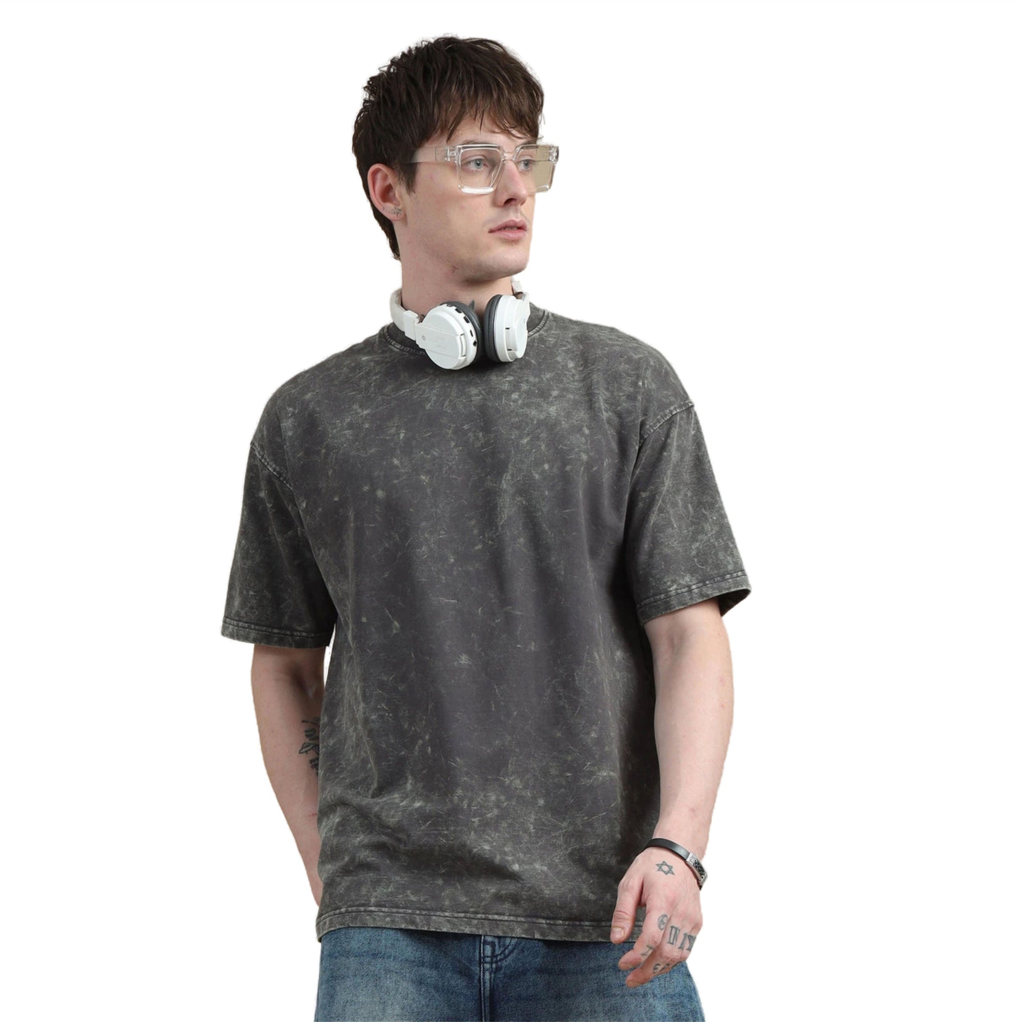 Person wearing a gray t-shirt and jeans with a white background