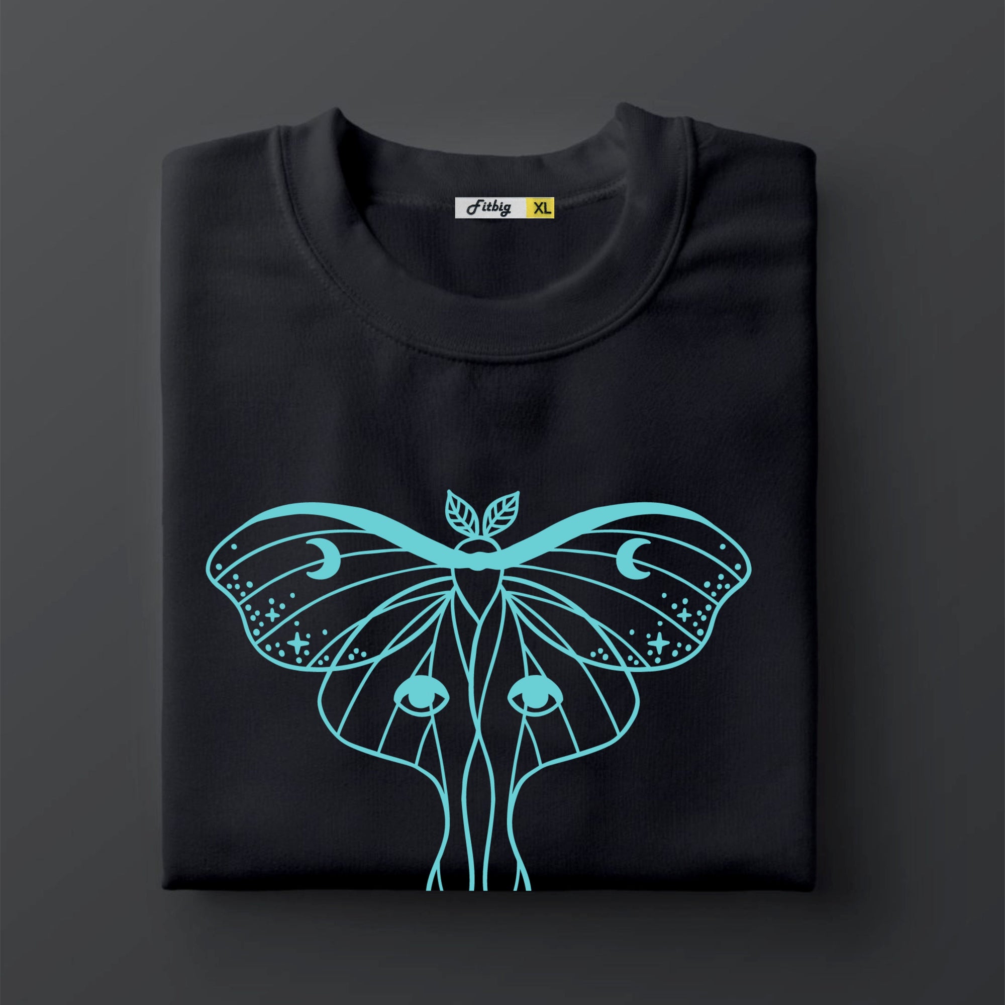 Black t shirt with a turquoise butterfly design on a dark background