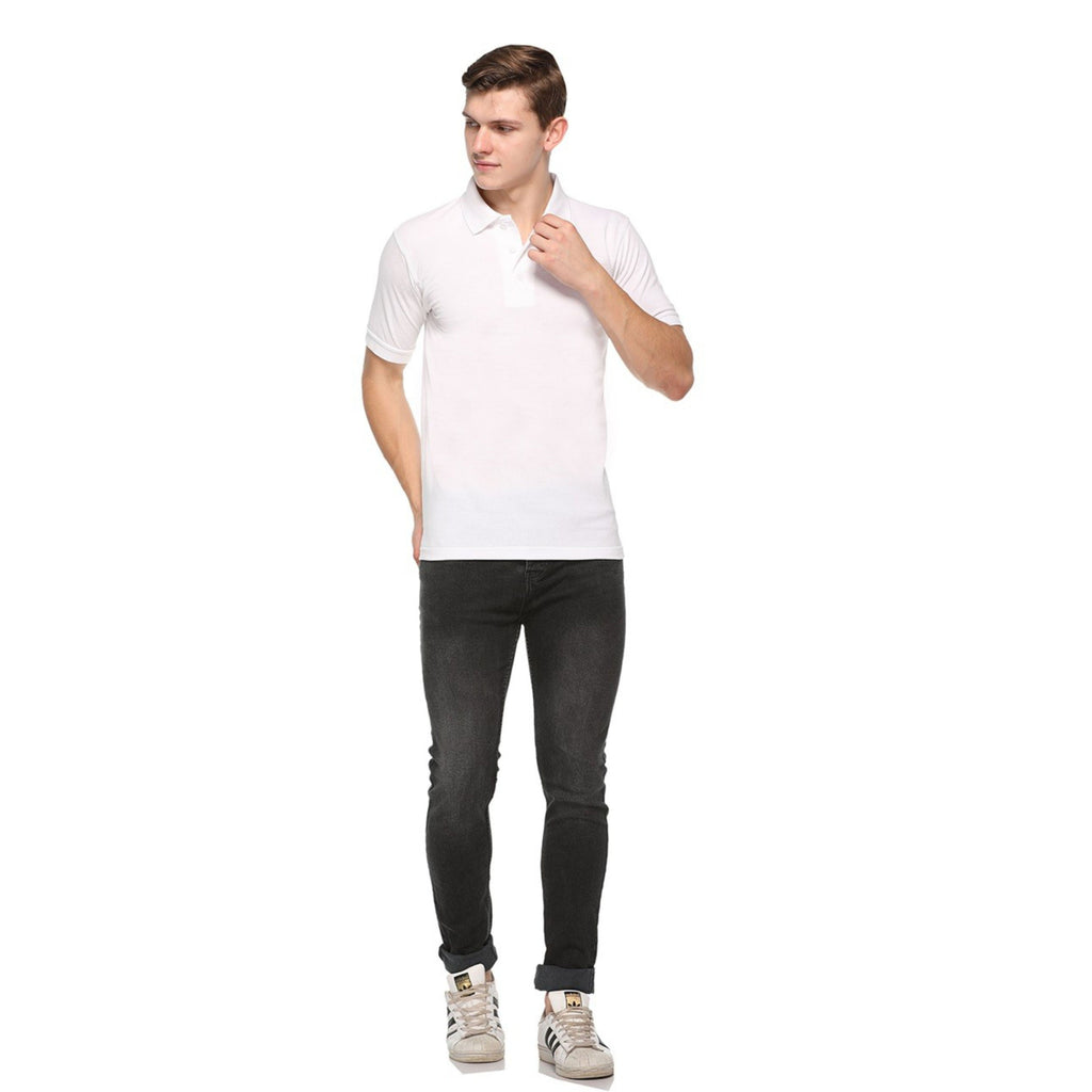 Man wearing a white polo t shirt and black jeans on a white background