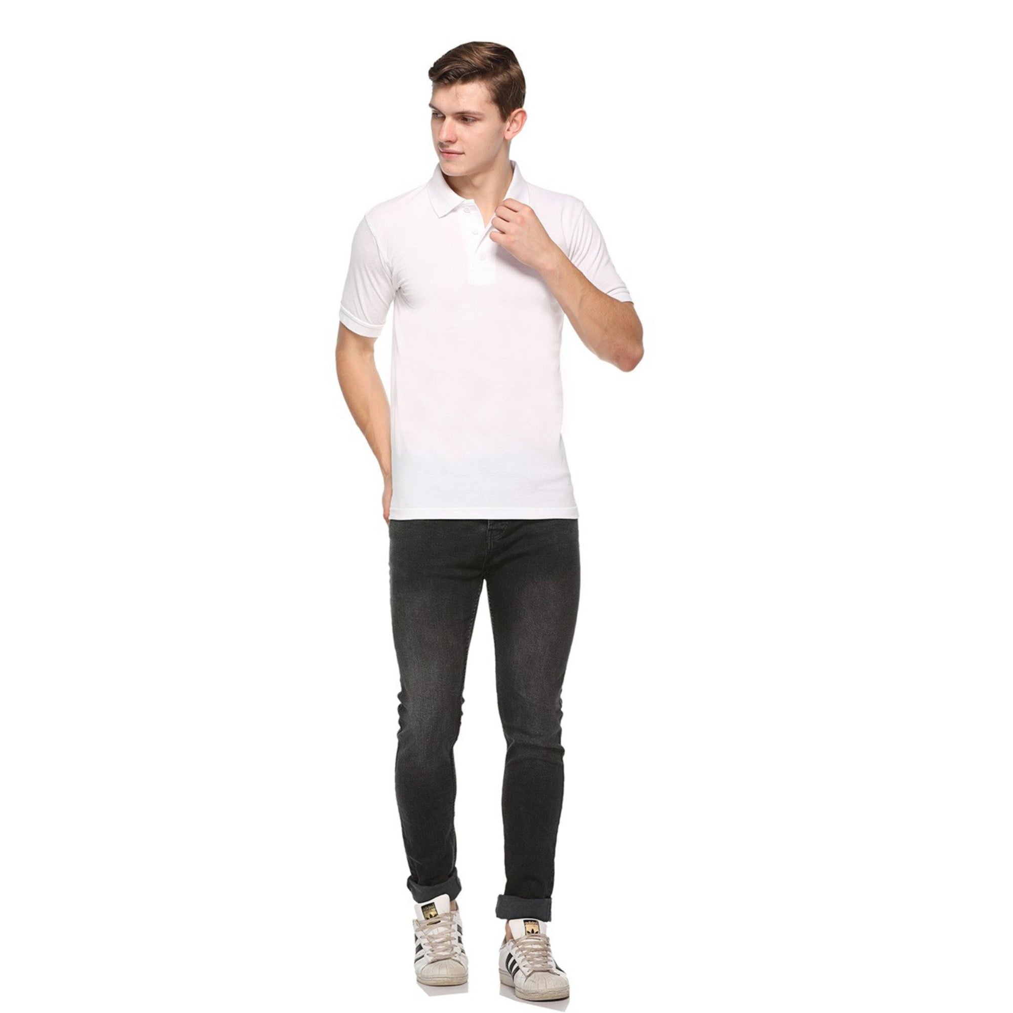 Man wearing a white polo t shirt and black jeans on a white background