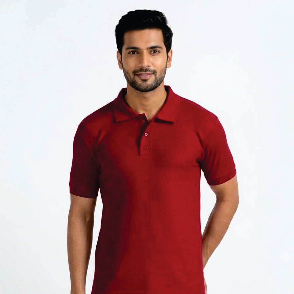 A man wearing a short-sleeve polo shirt in solid dark red, standing against a plain white studio background.