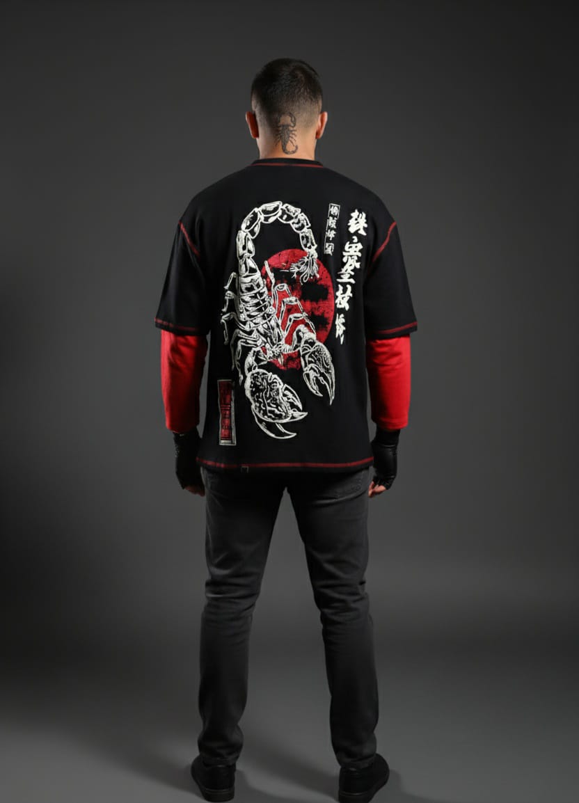 Person wearing a black and red shirt with a scorpion design on the back against a gray background