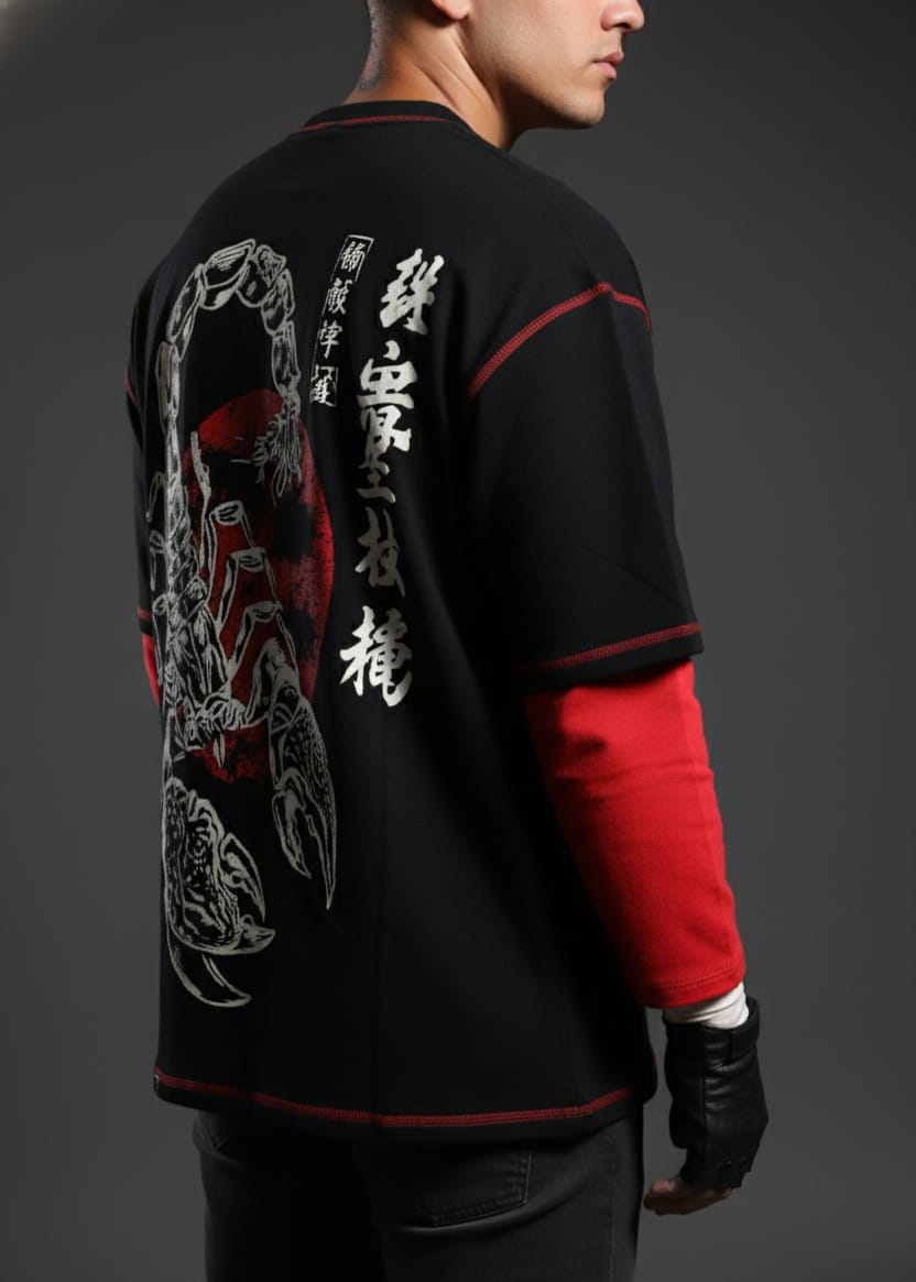 Person wearing a black jacket with red sleeves and intricate designs on the back against a dark background