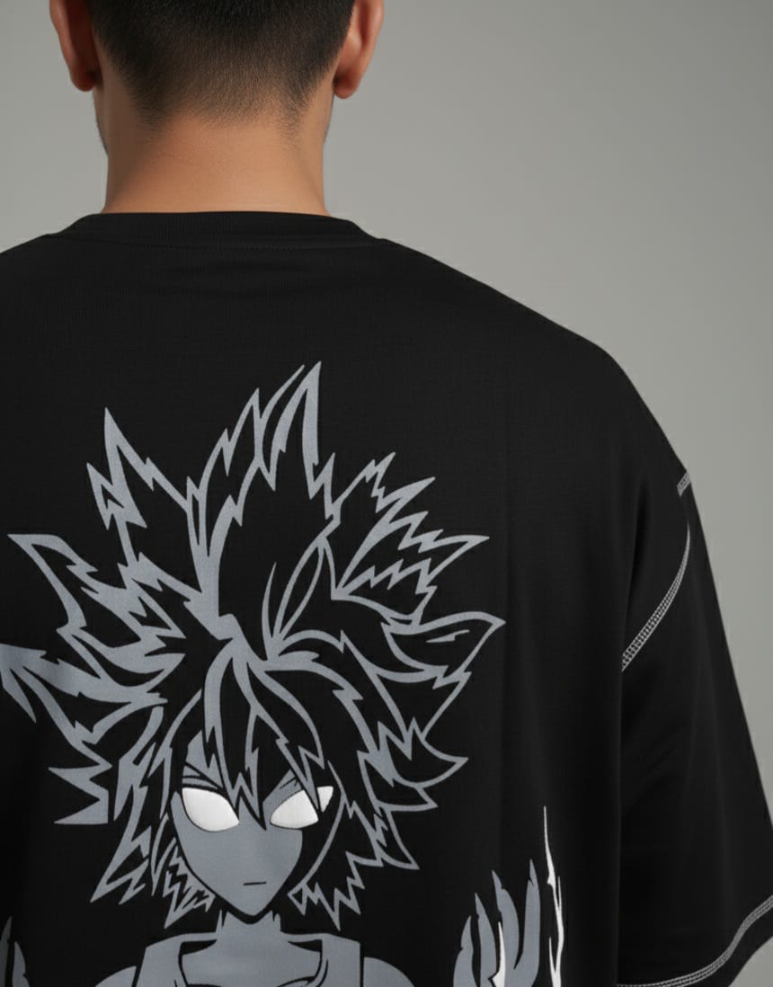 Person wearing a black t-shirt with a graphic design on the back against a gray background