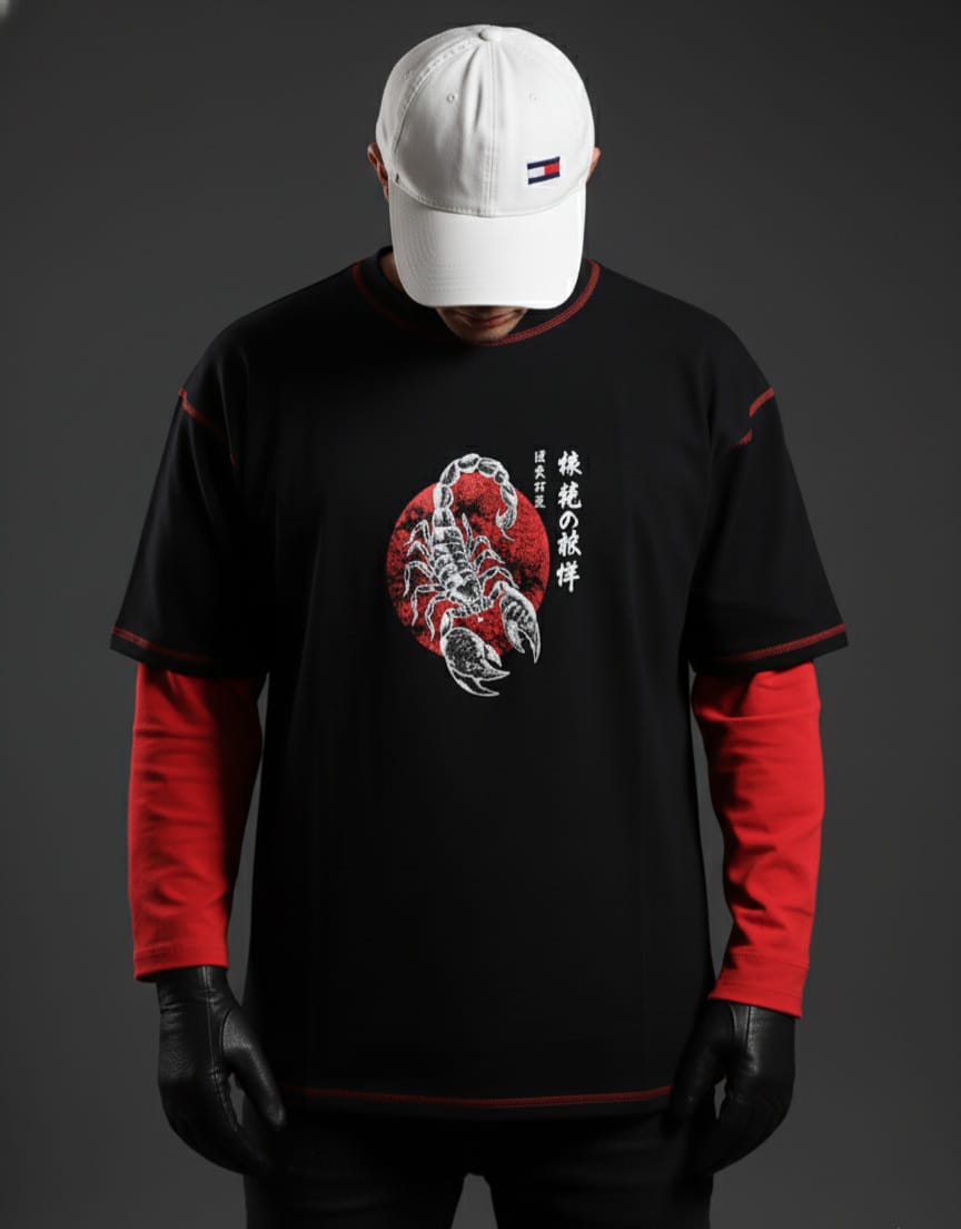 Person wearing a black and red long-sleeve shirt with a scorpion design on a gray background