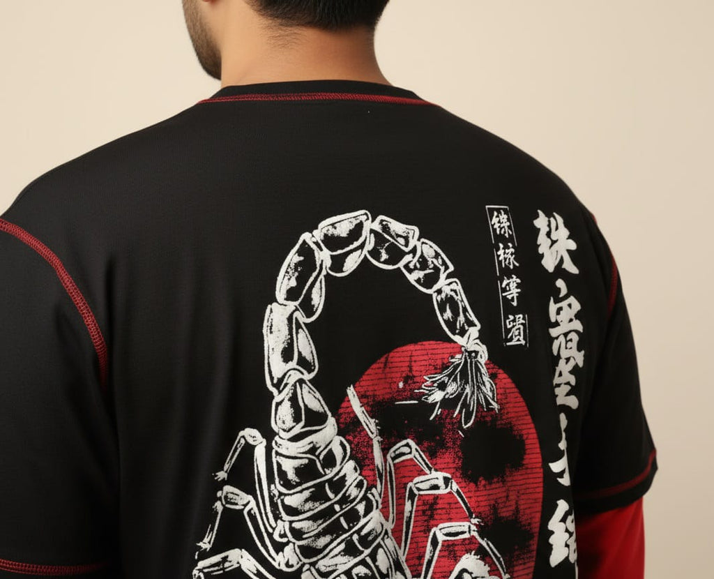 Black shirt with white scorpion design and red accents on a beige background